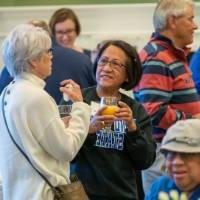 Two alumni drinking the celebratory mimosas.